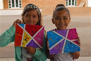 Two Saturday Explorers displaying their art 